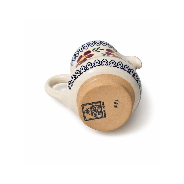 Charming hand painted Mosse Pottery creamer pitcher made in Ireland, featuring a colorful floral motif with decorative...