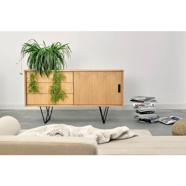 This compact dresser offers three elegant drawers and a stylish alcove with a sliding front. The drawers have a quiet and...