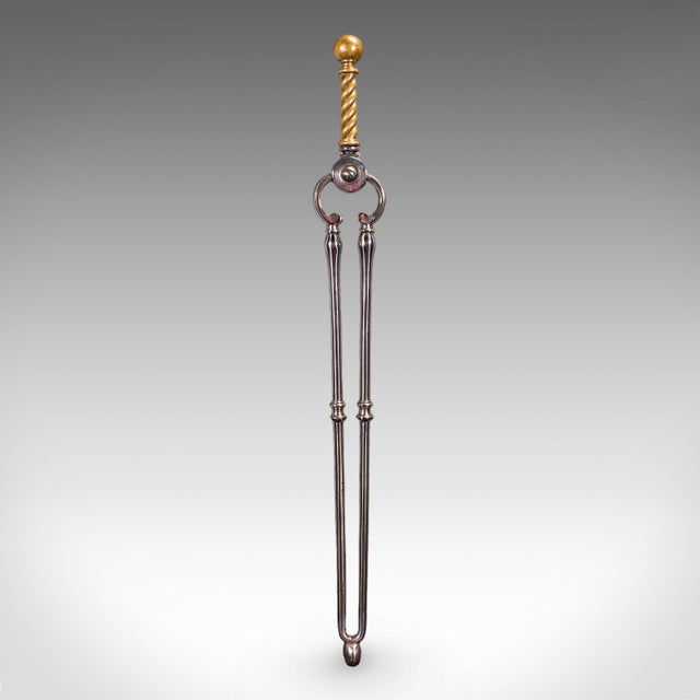 This is an antique companion set of three fireside tools. An English, steel and brass pair of tongs, poker and coal...