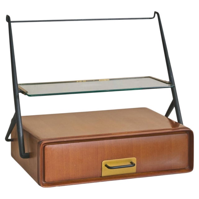 An Italian floating console or bedside table attributed to Silvio Cavatorta from the 1950s, crafted in richly grained teak...