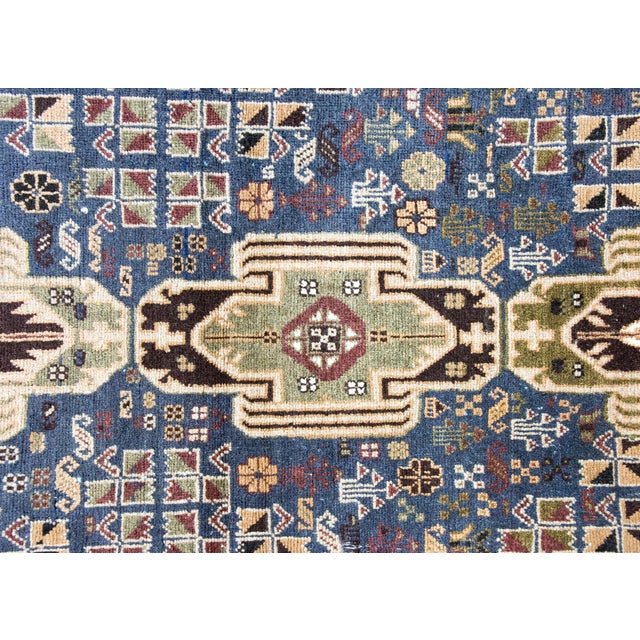 A wonderful late 20th century Afghani Baluch Rug with three large geometric, Art Deco inspired, medallions living amidst a...