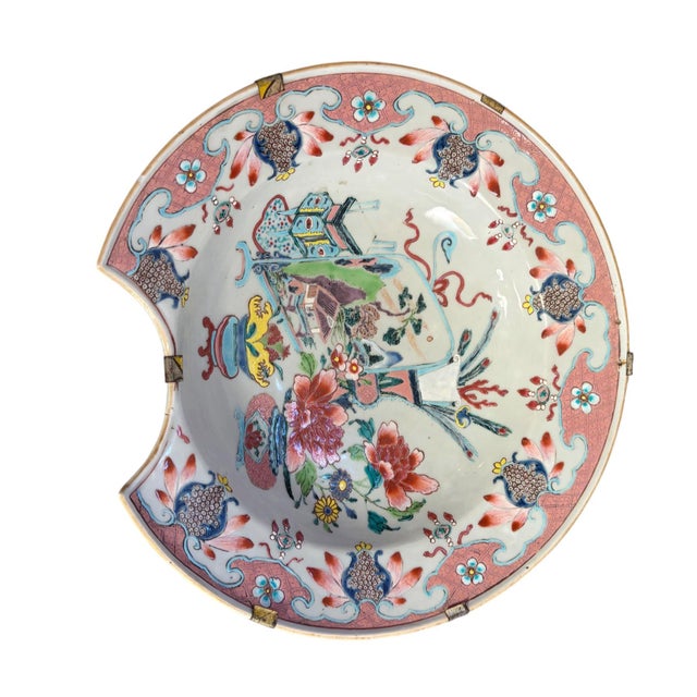 An 18th century Chinese export porcelain barber’s bowl, hand painted in the famille rose palette. The gently scalloped...