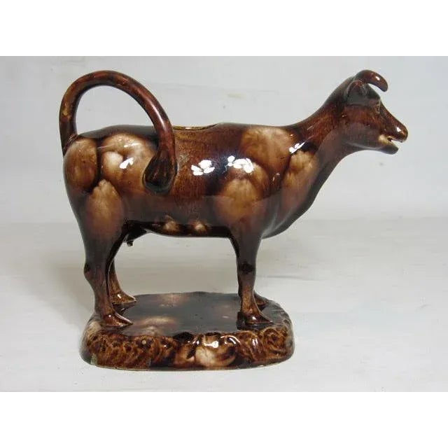 Brown glazed Staffordshire pottery cow creamer, c.1920’s Unusual in brown glaze, this cow creamer is well detailed and in...