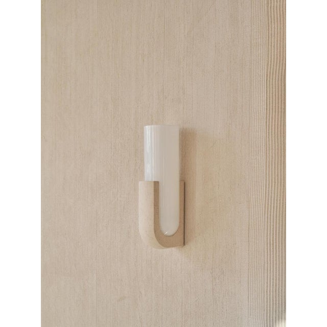 Pluto sconce in ceramic stone and white glass by farrah sit. Dimensions: w 9 x d 11 x h 31 cm. Materials: ceramic stone...