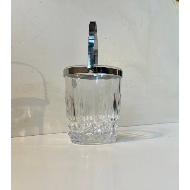 Stylish cut crystal ice bucket with chrome-plated accents. It was made in France circa 190-80 by Cristal d'Arques....
