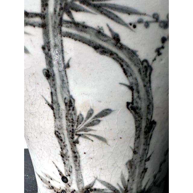 A large Korean white porcelain jar with underglaze decoration circa late 19th century of Joseon Dynasty. The vase has a...