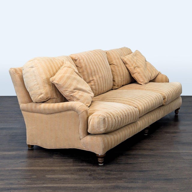 This Crate & Barrel 3-seat sofa features a classic beige striped fabric and includes three back cushions and two matching...