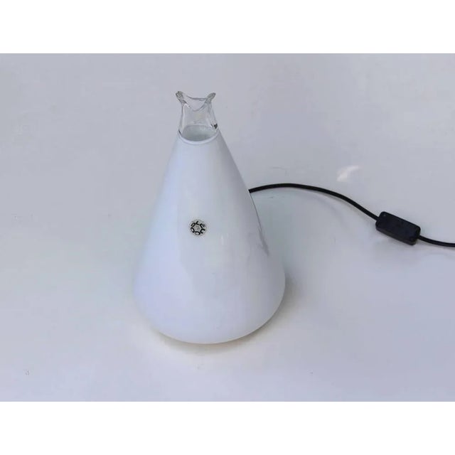 Buto lamp of well -known massari for Leucos, 1977. Milky and transparent blown glass lamp. Small flowing in the...