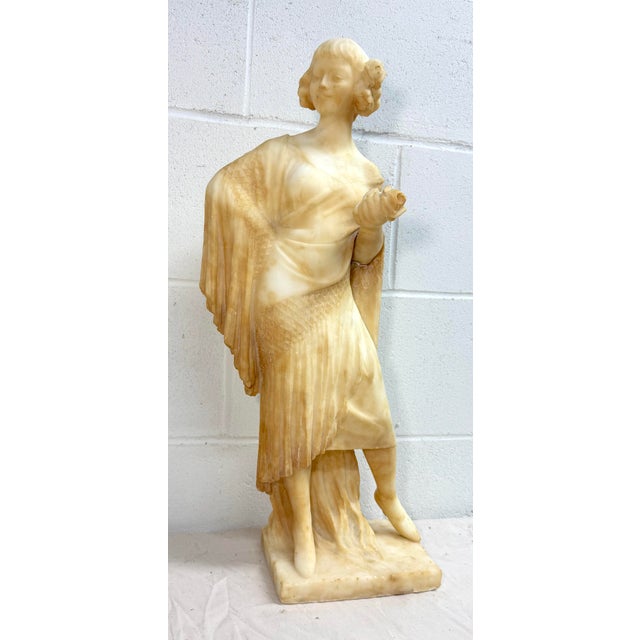 Delve into the timeless beauty of this antique hand-carved alabaster stone sculpture, a true testament to artisanal skill....