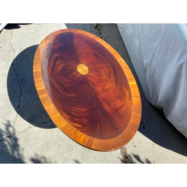 The Vintage Hekman Oval Mahogany Georgian Style Coffee Table with Red Flame Finish is a timeless and elegant piece of...
