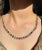 This is part of Chairish’s Fine Jewelry assortment. Multi Gemstone Necklace in 18K Gold studded with round cut emerald ,...