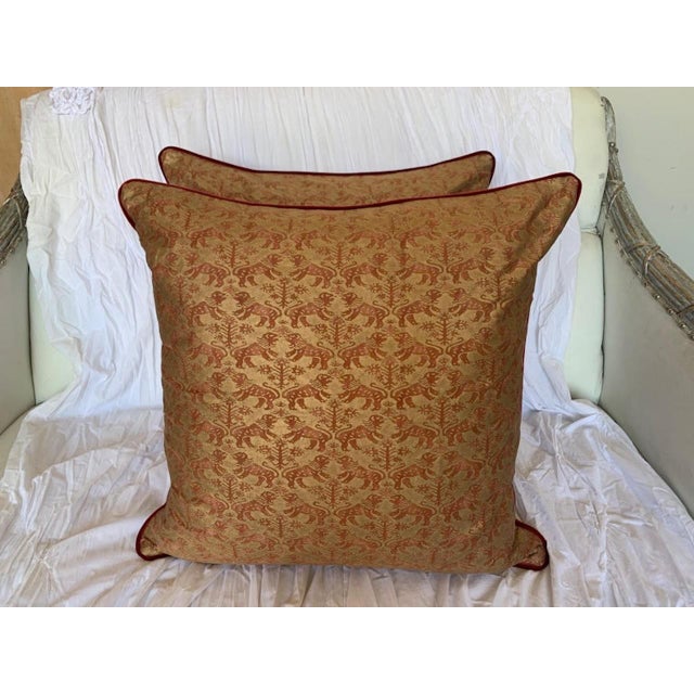 Pair of custom Richelieu patterned Fortuny pillows depicting Venetian lions in red & gold. The backs are velvet and the...