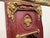 Charming French panel mirror finished in a rich burgundy red paint with parcel-gilt detailing. The frame is elegantly...
