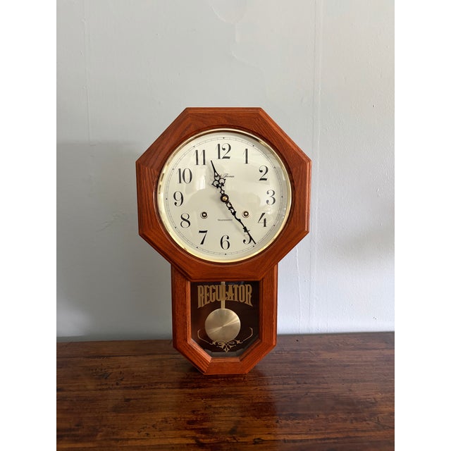 Vintage Seth Thomas Regulator wall clock featuring a beautifully grained octagonal wood case, beveled glass face, gold-...