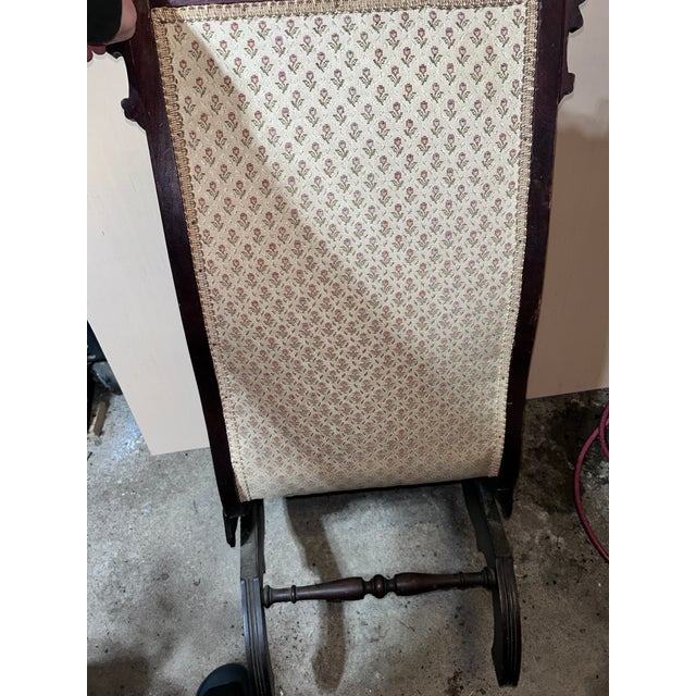 Solid hardwood (likely walnut) with carved crest, original frame, platform rocker base, upholstered seat and back, Sturdy...