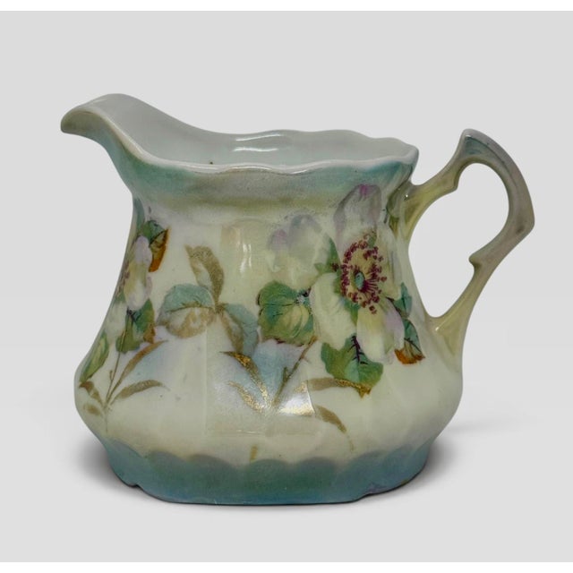 Vintage porcelain creamer, likely Bavarian, circa early 1900’s. Glossy white, fluted/ribbed body with a scalloped rim and...