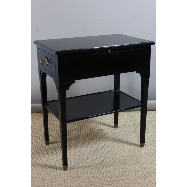 Side table Small reading table in ebonized wood in the Directoire style. This table has two side drawers and a leather-...