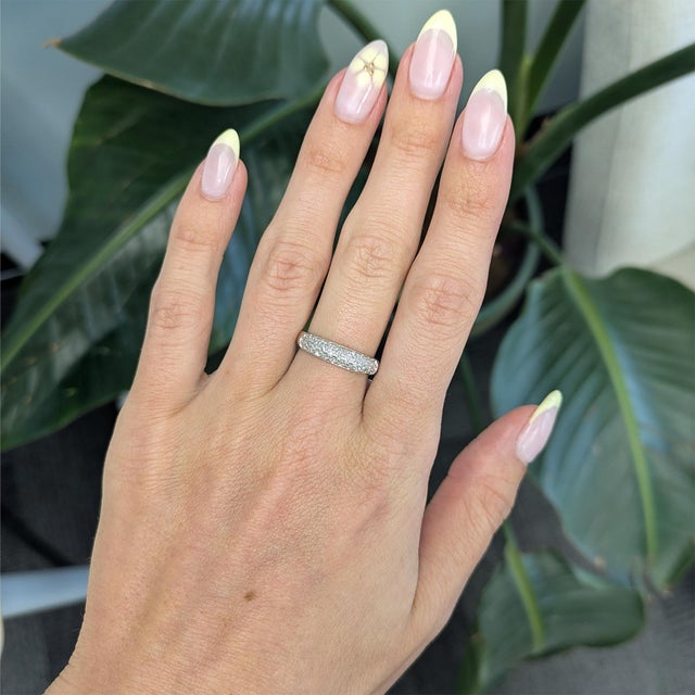 A timeless estate wedding band crafted in solid 14K gold with brilliant earth-mined diamonds for enduring elegance....