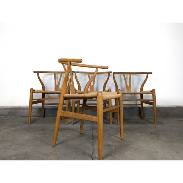 For sale is a vintage set of 4 Mid Century Modern “Wishbone” Chairs by Hans J. Wegner for Carl Hansen & Søn, circa 1970....