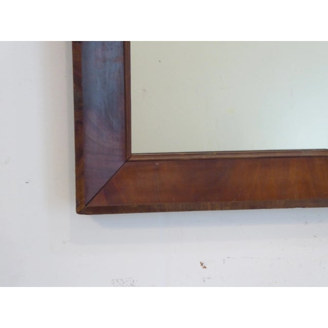 This mahogany mirror measures 35"H x 18"W and is ready to hang.