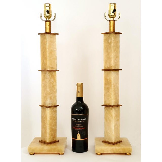 Offering a vintage pair of Italian Rialto Marble Art Deco style table lamps, circa Late 20th Century. These extremely...