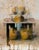 This oil on panel artwork presents a still life composition featuring a table with abstract forms, including large,...