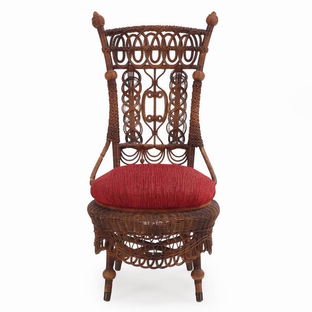 This extravagant Victorian wicker chair has wonderful detail including intricate weaves, braids, beads, and balls, all...