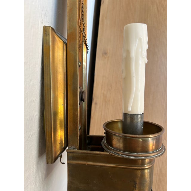 Pair of vintage brass wall sconces with vertical center spine, rectangular back plate, round bobeche, and upper dish...