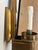 Pair of vintage brass wall sconces with vertical center spine, rectangular back plate, round bobeche, and upper dish...