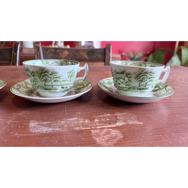Set of Four Enoch Wood's "English Scenery" Green Transfer Cups and Saucers, Circa 1940s A charming and collectible set of...
