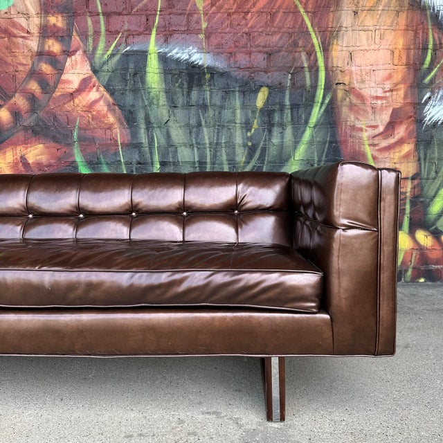 This is a bold and beautiful brown tufted vinyl sofa. It was made by the Kenmar Manufacturing Co. in Ohio. It is part of...