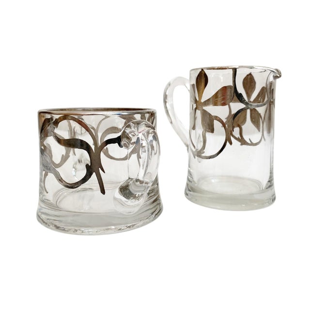 Elevate your dining experience with this exquisite Vintage Art Nouveau Silver Overlay Creamer and Sugar Bowl Set,...