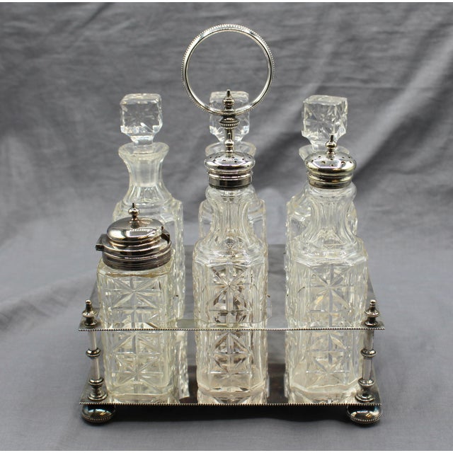 English silver plate & cut glass cruet set, circa 1880. Silver plate by Atkin Brothers, Sheffield (post 1853 marks). The...