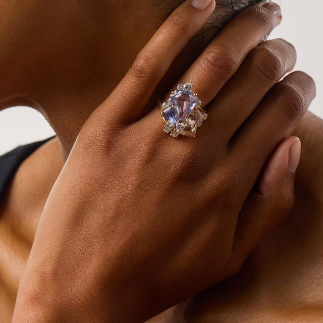 This exceptional Oscar Heyman cocktail ring showcases four breathtaking pastel-colored modified shield step cut sapphires...