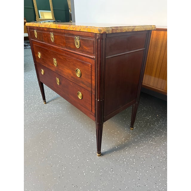 Beautiful French Louis XVI mahogany marble top commode. It features a stunning marble top over a bank of three drawers...