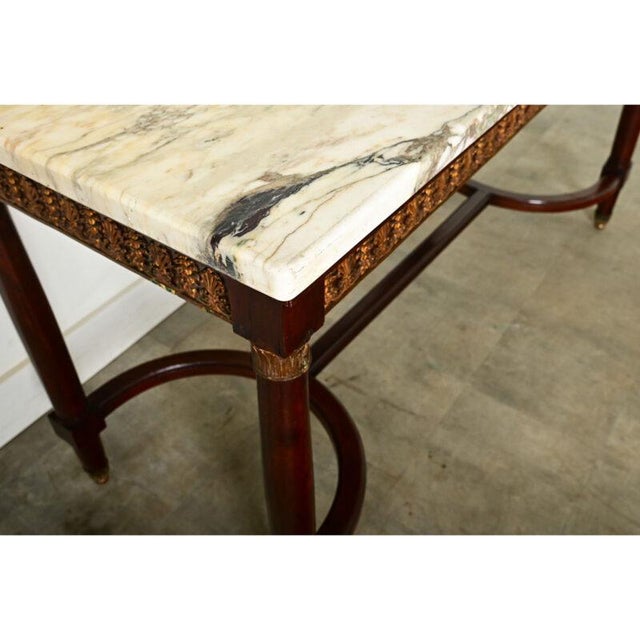 Dimensions: 32 ⅞” H x 63” W x 25 ¾” D A spectacular French mid-19th century Louis XVI style mahogany and marble center...