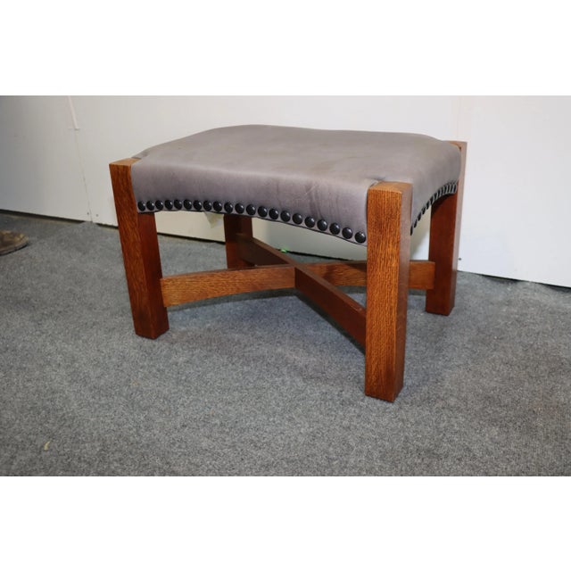 L & J.G. Stickley Footstool, arts and crafts style , solid oak base with leather upholstered seat , large brass rack trim...