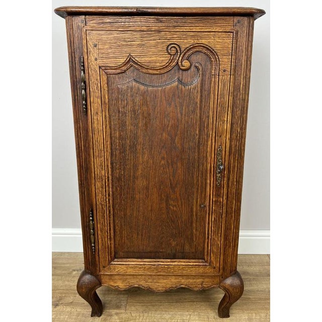 This elegant Antique French Cabinet showcases classic French craftsmanship with a beautifully aged oak finish, a single...