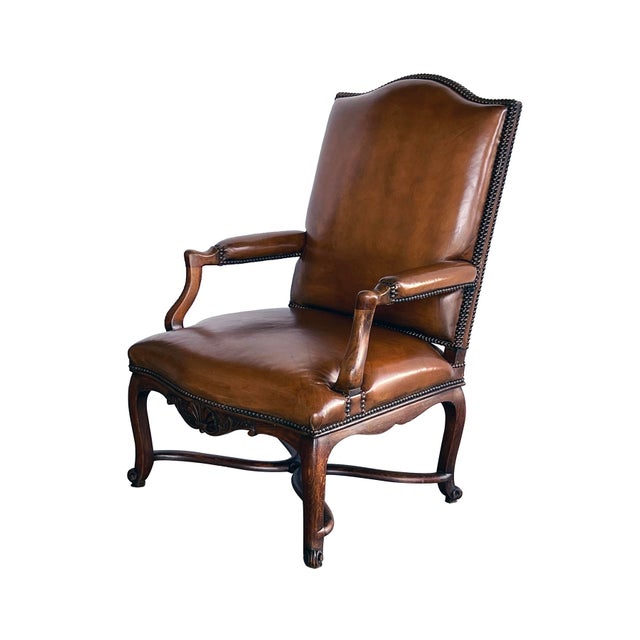 each tall upholstered back with shaped crest above a tight serpentine seat flanked by padded arms; over a scalloped apron...