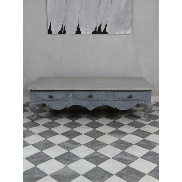 This coffee table is gray/blue in the frame and gray on the plate. The piece of furniture has three drawers and is perfect...