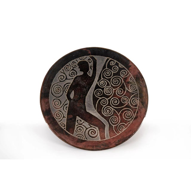 Clyde Burt ceramic charger in glazed stoneware with incised image. Signature to underside: [CB]. American, circa 1965