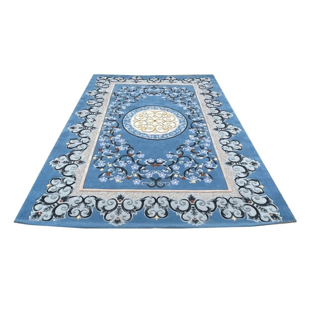 This is a handmade wool blend area rug or carpet with a continuous artistic floral pattern theme. It can be used as a...