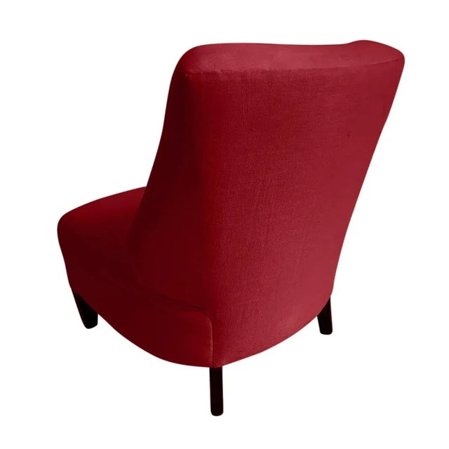 Pair of modern club chairs. The chairs are done in a red chenille. The legs are done in a dark expresso finish. More than...