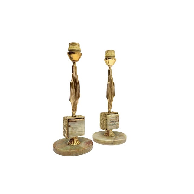 Very elegant table lamps featuring a combination of green-veined onyx stone and a fluted brass base, with decorative...