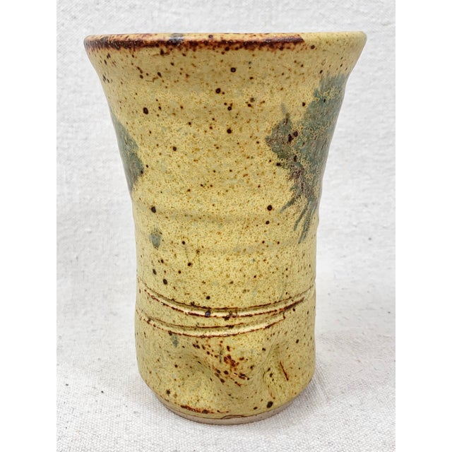 Interesting vintage pottery vase. Handmade and signed on the bottom. Earthy tones in warm blue gray, Off white/cream, and...