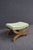 Cherry wood bench with an X-form base, carved center medallions, and an upholstered seat. Finished in a warm cherry tone...