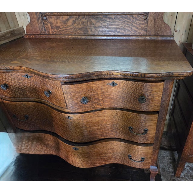 This exceptional late 19th-century Victorian dresser is crafted from quarter-sawn tiger oak, highlighting the wood's...
