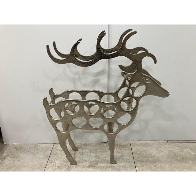 This polished cast aluminum wine rack holds 11 bottles of wine. Very unusual whimsical firm Can see this in a country...