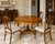 A beautifully crafted round dining or center table by Theodore Alexander, featuring an exquisite burl walnut veneer top...
