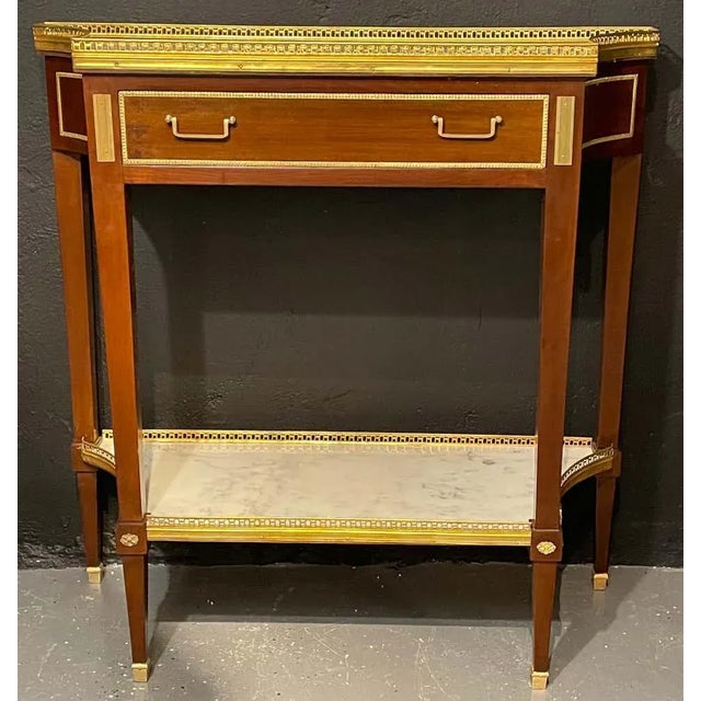 A pair of Russian style console tables having the Maison Jansen look and flair for design. This finely crafted and design...